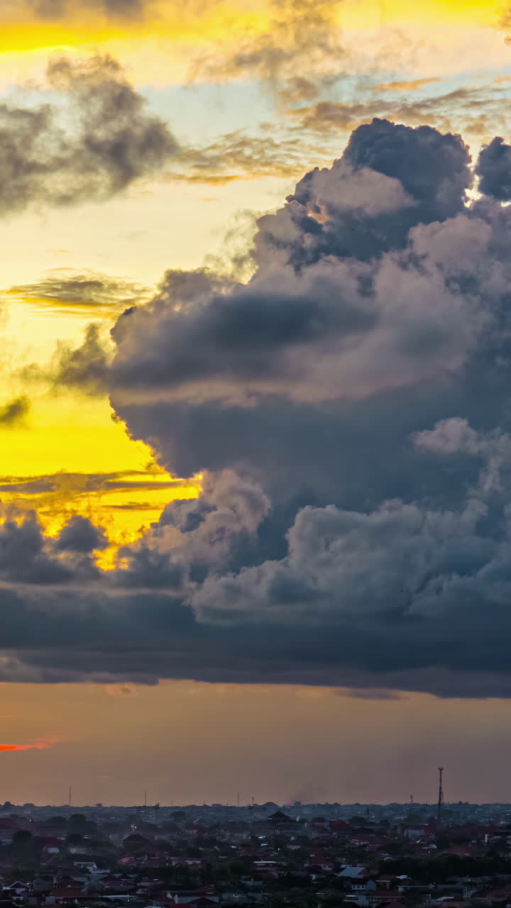 Bursting of thick cumulus clouds in sunset sky in Bali, Indonesia.