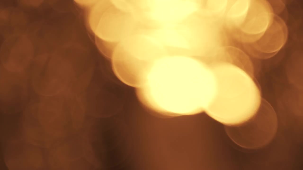 Abstrakt gyllene ljus bokeh-effekt på mörk bakgrund