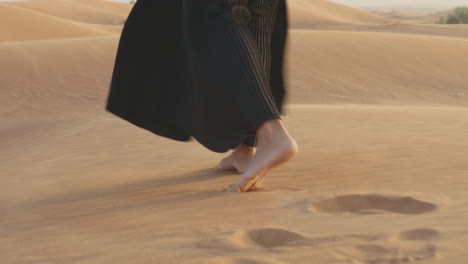 Close-Up-Of-An-Unrecognizable-Muslim-Woman-Walking-Barefoot-In-The-Desert-1