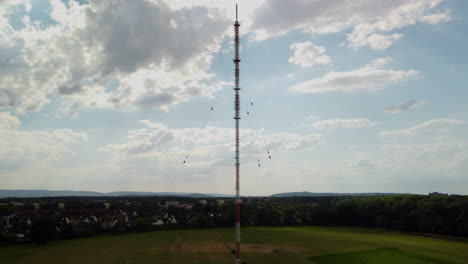 climbing an antenna in front of a village