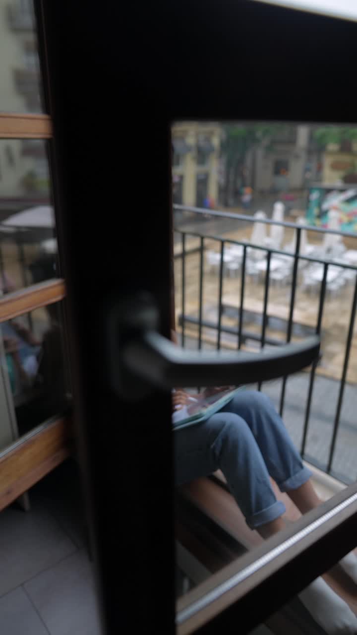 도시 의 발코니 에서 스케치 하는 여자