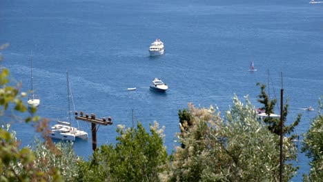 view of ships and yachts sailing on the waters of the ionian sea near corfu island