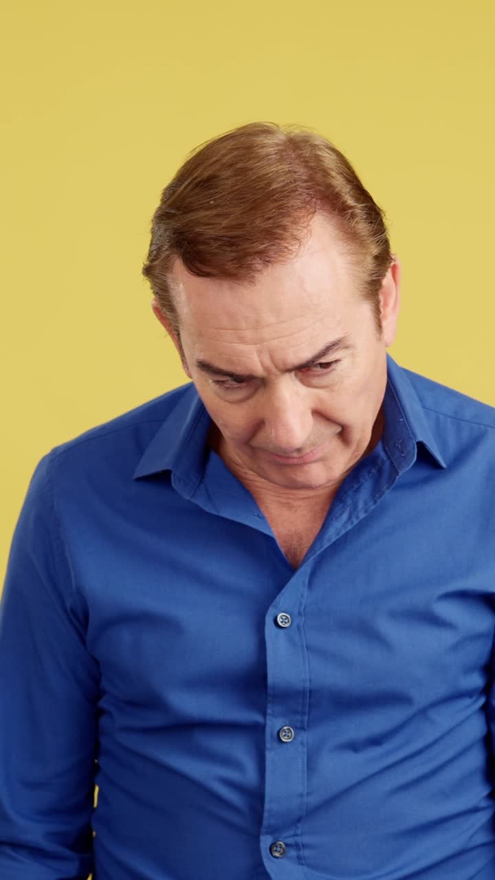 Man looking down with thoughtful or concerned expression