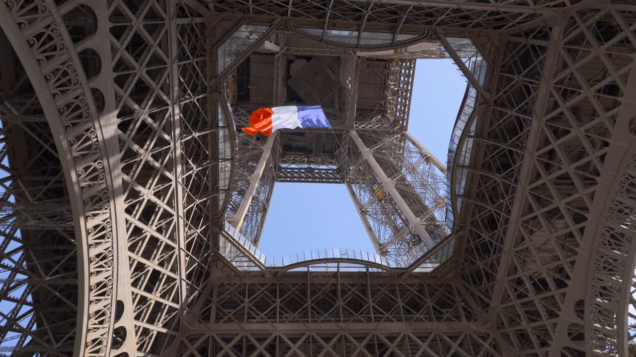Giant French flag under the Eiffel Tower in Paris, France