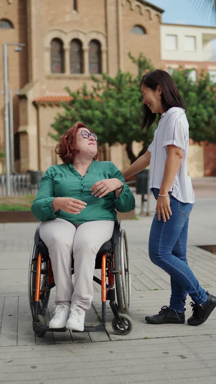 Woman in Wheelchair Talking to a Friend