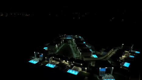 aerial flyover illuminated pools and vacation homes, night in rhodes, greece
