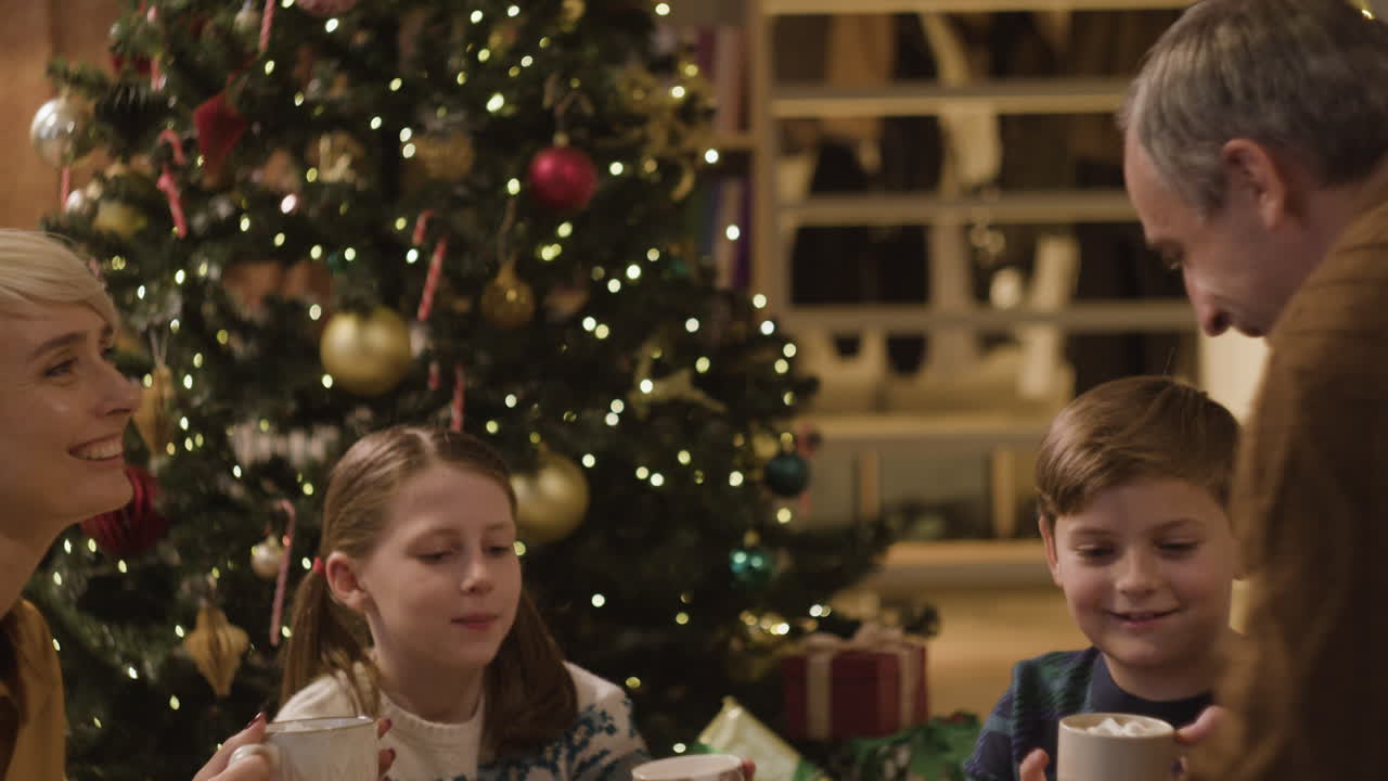 Family gathering around the Christmas tree