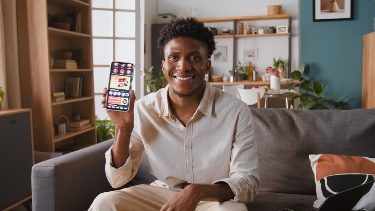 Man showing smartphone at home