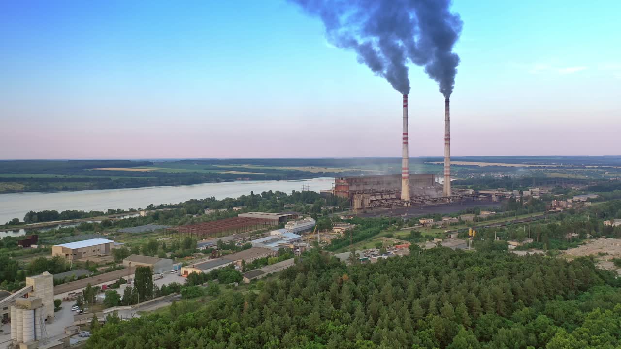 Industrial zone in countryside. Air pollution by smoke coming out of two factory chimneys