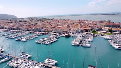 aerial drone video of famous marina of lefkada island town with anchored yachts and sail boats, ionian, greece