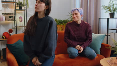 two offended disappointed lesbian women family couple ignoring each other after quarreling at home