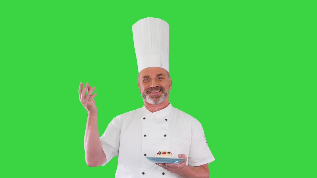 chef barbudo haciendo un delicioso gesto con el postre en sus manos en una pantalla verde, llave de croma