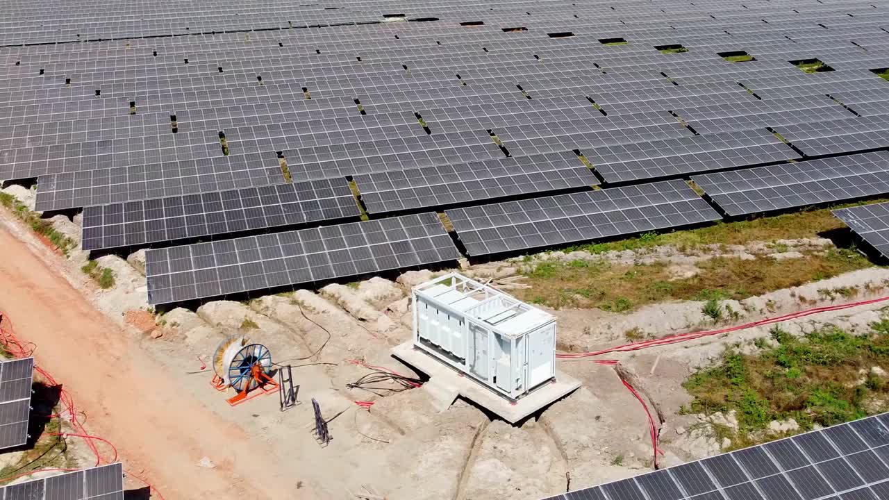 Wide orbit overview of renewable energy solar power plant inverter with cable laying progressing