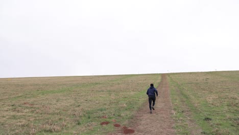 asian-male-runs-up-hill