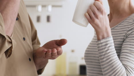 couple having coffee and conversation in kitchen