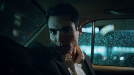 elegant model sitting auto evening portrait. serious business man looking camera