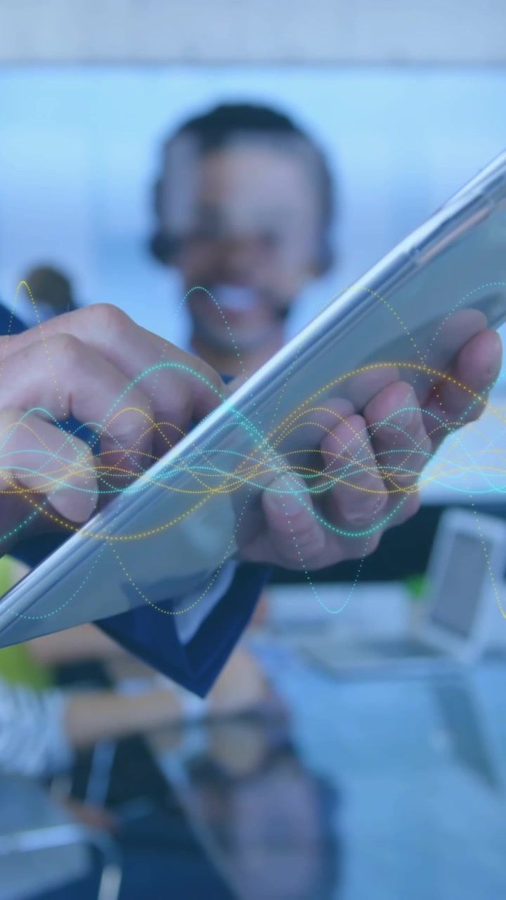 Animation of data processing over mid section of businessman using digital tablet at office