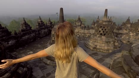 4k resolution video of travel girl embracing sunrise at borobudur temple, indonesia . people discovery asia concept