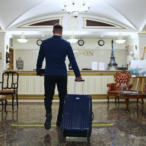 businessman walking to hotel lobby