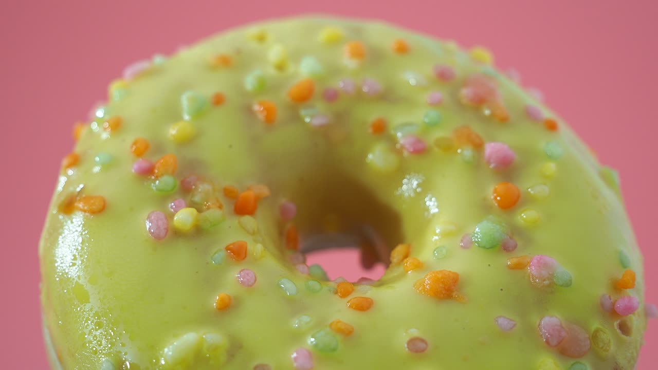 Fresh lemon donut on a pink background. lemon donut