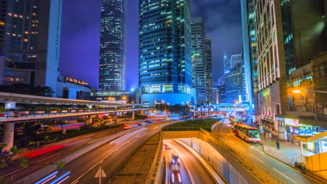 4k time lapse view of traffic light and modern building at night hong kong city