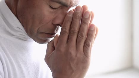 man praying to god with hands together caribbean man praying with grey background stock video stock footage