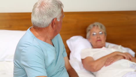 Senior-couple-not-speaking-after-an-argument-on-bed