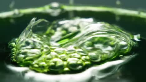 mesmerizing close-up of vibrant green fluid dynamics captured in two frames - a journey through bubbling textures and translucent shapes