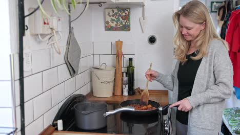 a woman cooking a meal in her kitchen