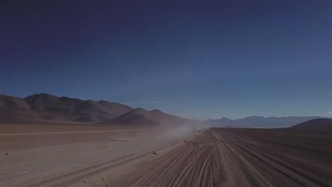 Epic-aerial-view-of-driving-through-surreal-Salvador-Dali-deserted-landscape,-Bolivia,-Chile