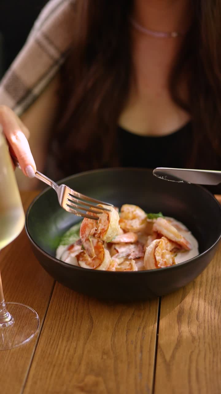 mujer comiendo pasta de camarón cremosa
