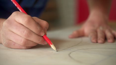 Artesano-Trabajando-En-Un-Proyecto-Artístico-Utilizando-Lápices-Rojos-Y-Papel.