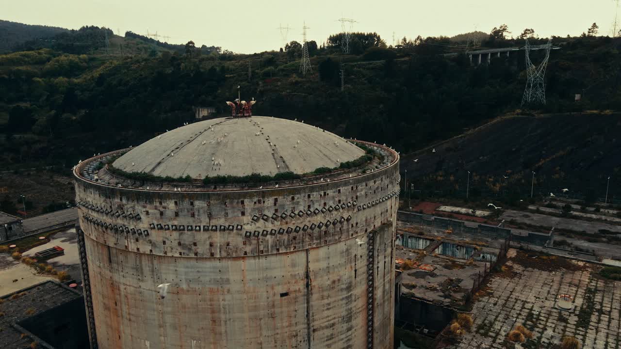 Aerial View of Abandoned Concrete Cooling Tower with Flying Birds