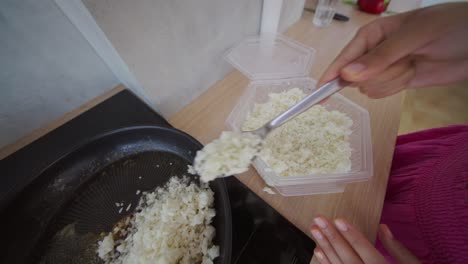 cooking cauliflower rice in a frying pan