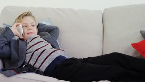 boy as executive relaxing on the sofa and talking on the phone 4k 4k