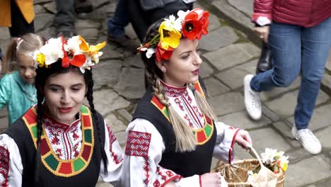 happy procession of smiling bulgarian girls in traditional dress in slow motion