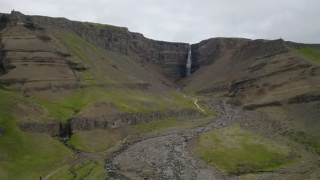 Aerial-flight-towards-rural-Hengifoss-Waterfall,-the-second-tallest-waterfall-in-Iceland,-located-in-east-Iceland