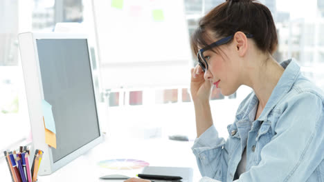 Attractive-creative-designer-working-sitting-at-her-desk-