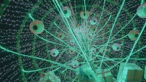 The-Above-View-Of-A-Giant-Christmas-Tree-With-Hanging-Round-Lanterns,-Small-Gifts,-And-Christmas-Lights-During-Evening---Close-Up-Shot