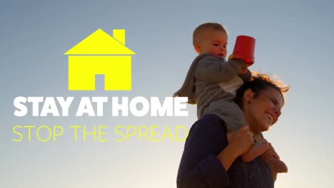 Animation-of-yellow-house-with-social-distancing-message-over-Caucasian-woman-holding-her-baby-on-he