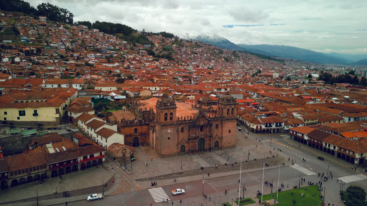 Plaza de Armas and Cusco Cathedral anchor the historic heart of Cusco Peru, aerial medium approach backdrop