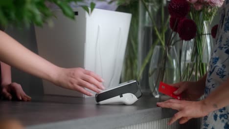 customer paying with credit card at a flower shop