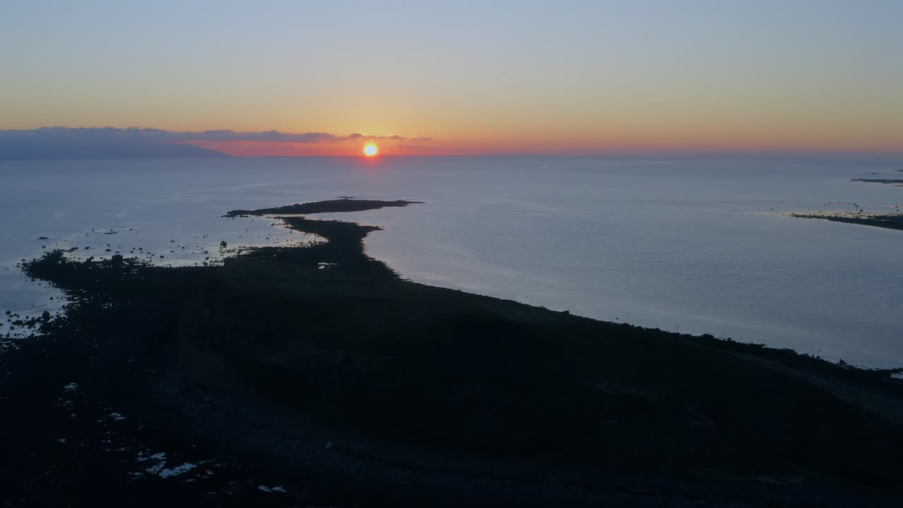 Aerial drone shot of an Irish bay at sunset with crisp, high-contrast lighting