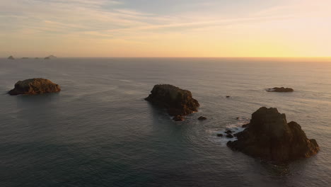 dramatic view of sea stacks at the oregon coast with glowing sunset sky