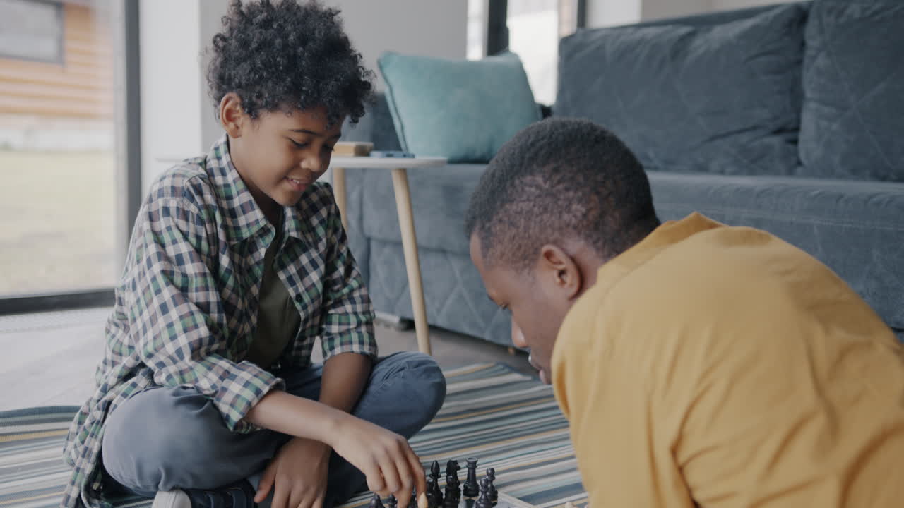 Father and Son Playing Chess at Home