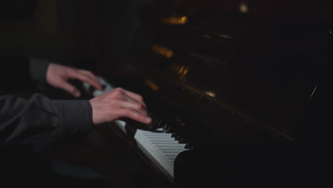 person playing piano in the dark