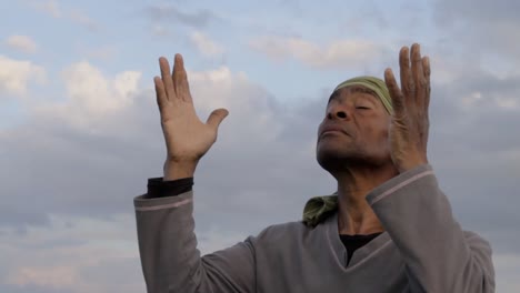 man praying to god caribbean man praying with blue sky in the background stock video