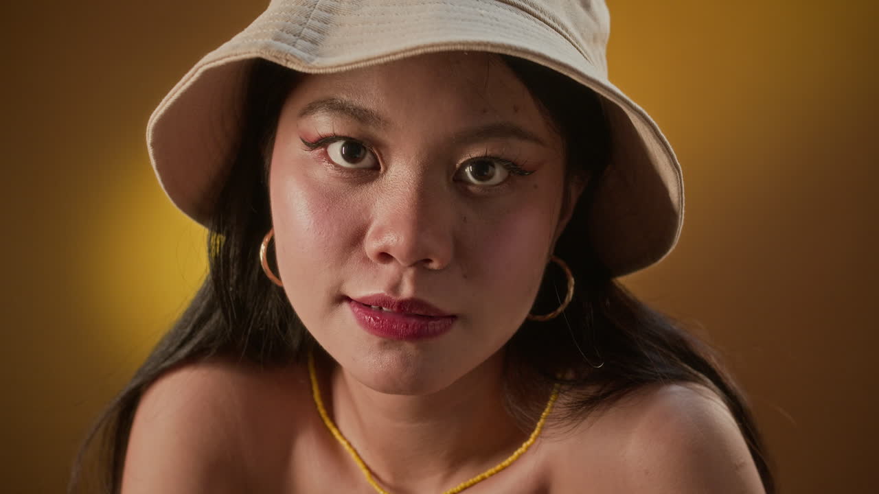 Gen Z Asian Girl Vibing to Music on Yellow Background