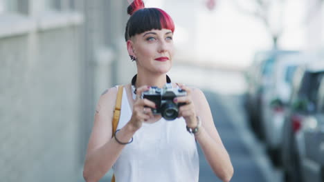 a young woman taking photographs with a camera