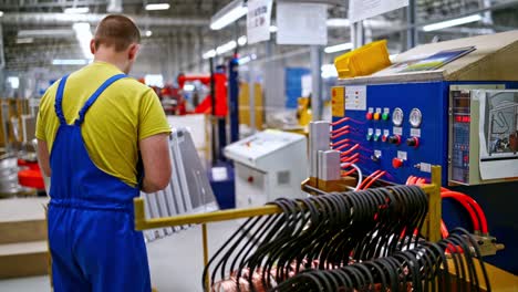 interior of industrial working place at factory. worker in blue uniform at work. industrial concept. department inside a factory.